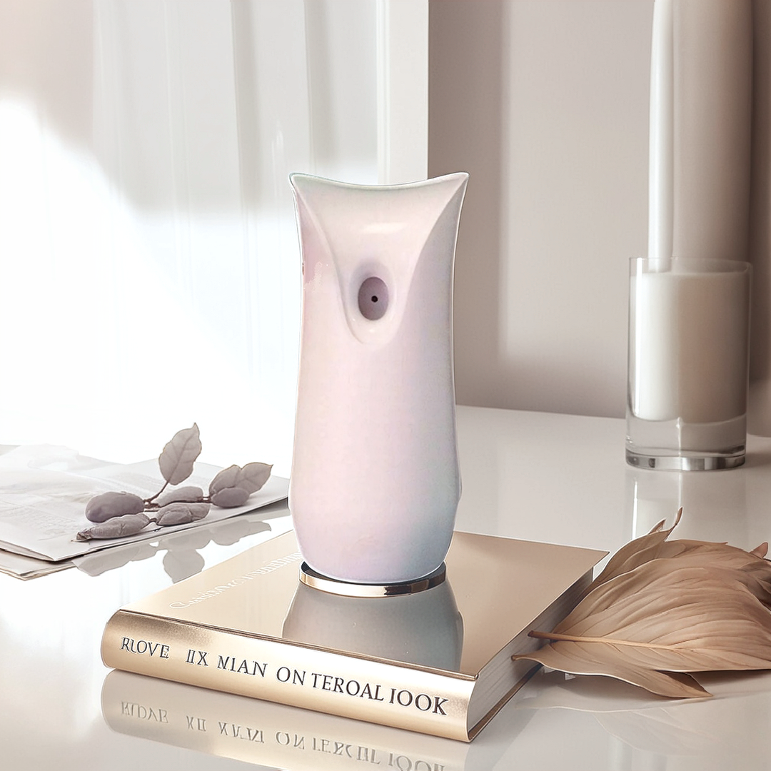 A pastel-colored device, the White Decorative Display SpyCam, sits on a stack of books with reflective surfaces. Surrounded by a dried leaf and candle, it blends style with covert surveillance technology.