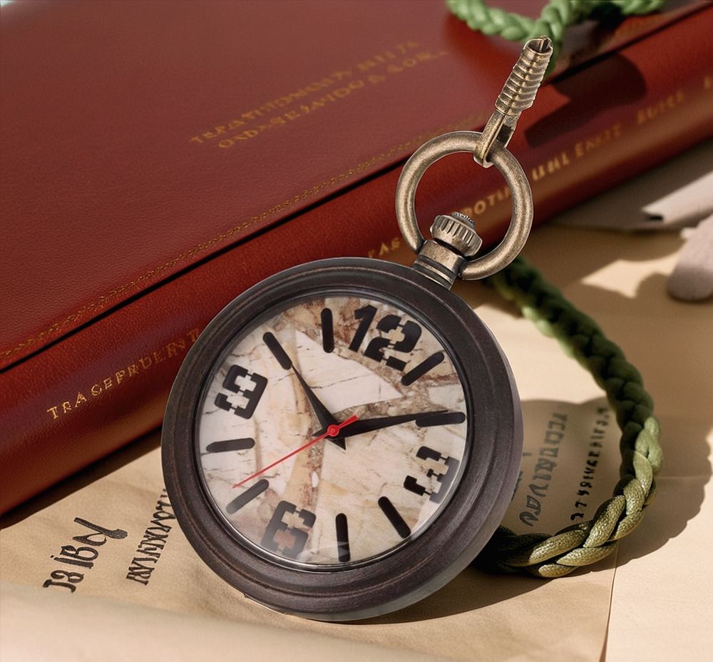 The Vintage Style Pocket Watch, crafted from dark wood with a marble-patterned face and green braided cord, rests atop documents and a closed red book.
