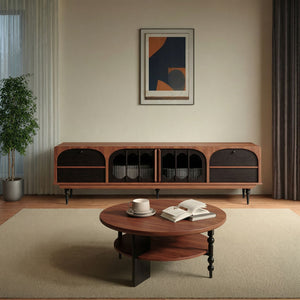 A modern living room featuring a round wooden coffee table, a cup and open book, the Antique TV Cabinet Combo Set, framed abstract artwork, a potted plant, and neutral curtains.