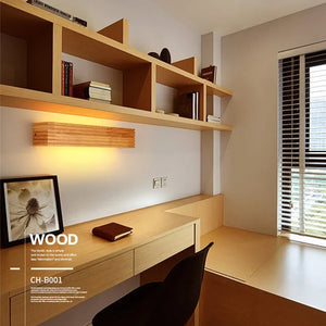 A minimalist study with a Scandinavian design features a wooden desk, shelves, and a chair. The organic materials vibe is enhanced by the Rectangle Wooden Wall Light and framed picture above the desk. A large window with blinds on the right brings in natural light.