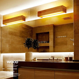 Modern bathroom with warm lighting from a Rectangle Wooden Wall Light, large mirror, tan tiles, and a potted plant on the counter, all embracing Scandinavian Design.