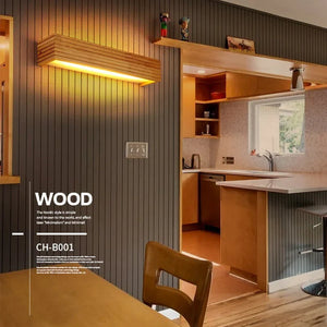 A modern kitchen showcasing organic materials and Scandinavian design elements, such as wooden cabinets and paneling. It includes a small counter with stools, all beautifully accented by the Rectangle Wooden Wall Light made from natural wood.