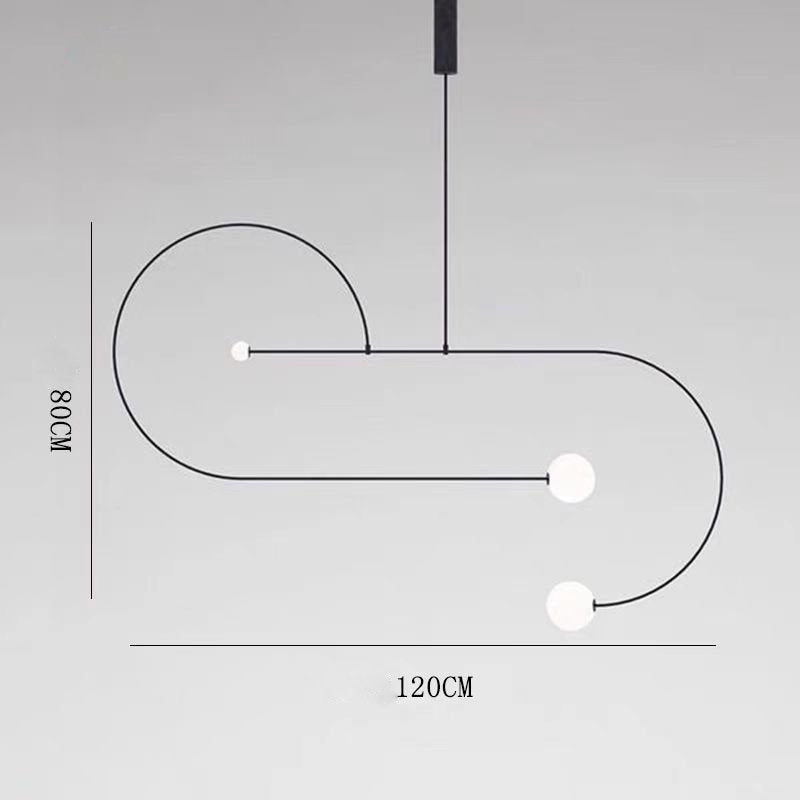 The Minimalist Line Light, a modern black metal fixture, showcases three white spherical bulbs on elegant curves. It features a sleek mounting system and measures 120 cm in width and 108 cm in height, adding an artistic touch to any space.