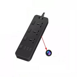 A black Power Strip SpyCam equipped with multiple electrical outlets and USB ports. A red arrow indicates a hidden camera lens cleverly integrated into the side of this covert surveillance device, discreetly recording in 1080P HD video quality.