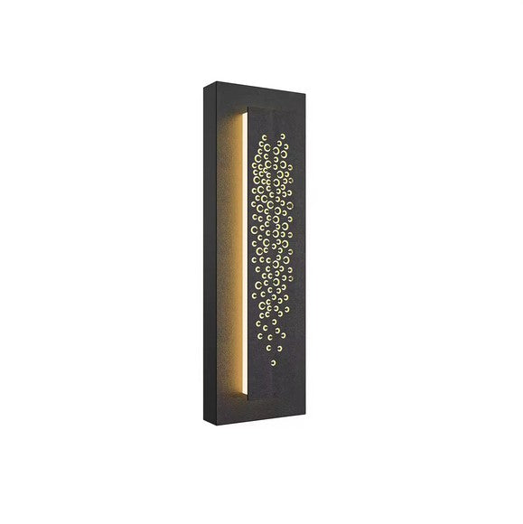 A rectangular black wall light fixture with a vertical line of illumination on the left and a decorative pattern of circular holes on the right, creating a striking focal point.