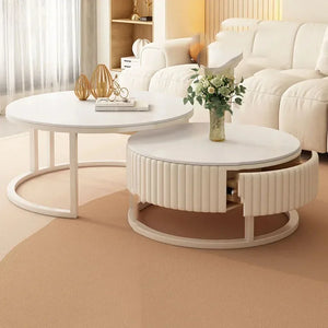The Luxury Round Coffee Table Set includes two tables: one styled with a vase and books, the other minimalist with an open drawer and floral arrangement, perfect for your living room.