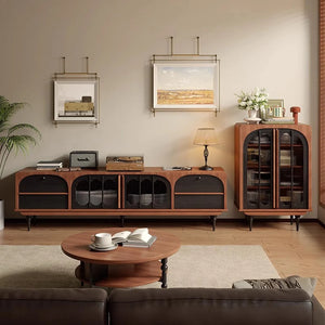 A modern living room featuring the Antique TV Cabinet Combo Set—includes a low wooden TV stand, glass-door storage cabinet, round coffee table, wall art above, plus decor accents like a plant and table lamp.
