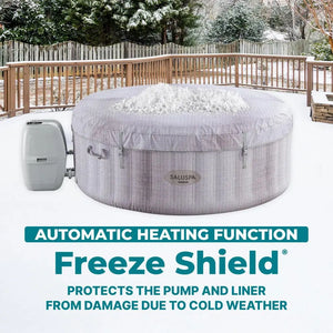 The Inflatable Hot Tub is pictured on a wooden deck with snow atop its cover, highlighting its automatic heating and freeze protection features. This round Inflatable Hot Tub is ideal for enjoying a cozy outdoor spa experience, even in cold weather.