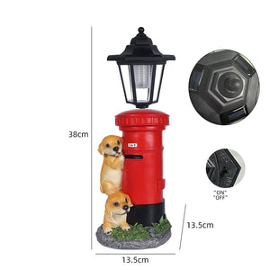 Introducing the Solar Dog Light – a solar-powered, red mailbox lamp adorned with two adorable puppy figurines at its base. Measuring 38cm in height and 13.5cm in width, this charming outdoor decor piece evokes the timeless elegance of a Victorian post lantern, making it an ideal porch or garden light. Inset images highlight the built-in solar panel and convenient on/off switch for effortless use.