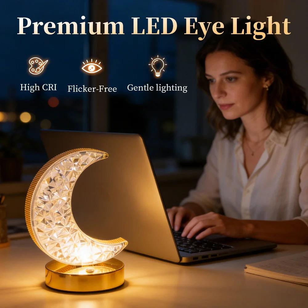 A woman works on a laptop at a desk, illuminated by the Crystal Table Lamp—a crescent moon-shaped LED bedside lamp. Text above highlights features: High CRI, Flicker-Free, Gentle lighting.