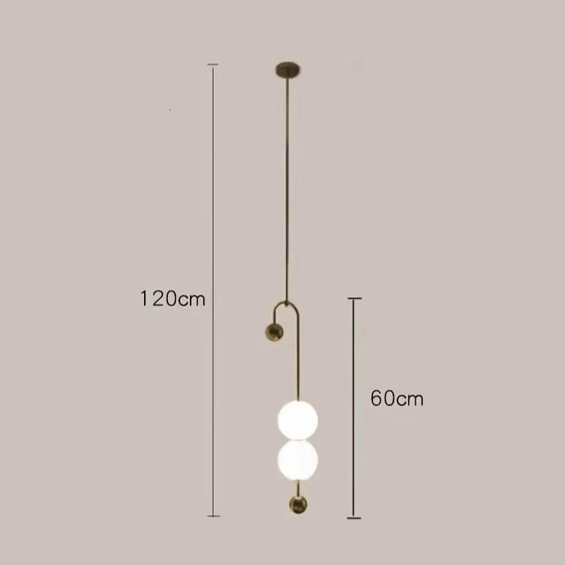 Discover the artistic charm of the Minimalist Line Light, featuring dual white globes on a sleek brass rod. With a total height of 120 cm and a 60 cm section for the globes, it elegantly enhances any space.