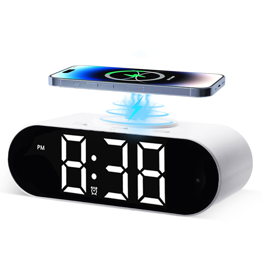 The Digital Clock Charger SpyCam displays 8:38 PM on its large LED screen and features a wireless charging pad on top for your smartphone.