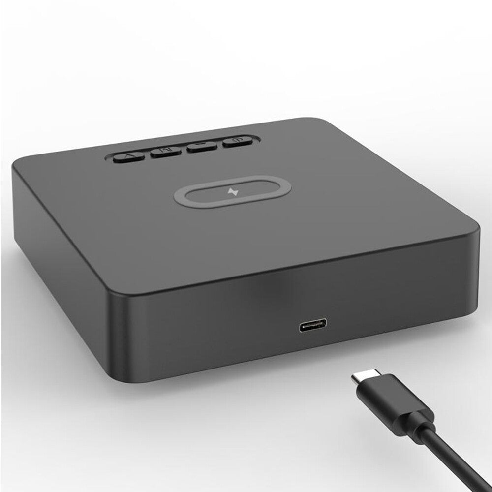 The Wireless Charger Clock SpyCam is a black wireless charger featuring three buttons, a central charging symbol, and a USB-C port; a USB-C cable appears in the foreground.