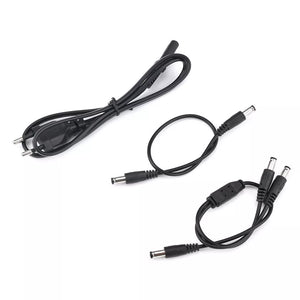 Three black cables are shown: a coiled power cord with a two-prong plug, a short DC power extension, and a Y-shaped DC splitter cable for your Portable UPS for WiFi Router.