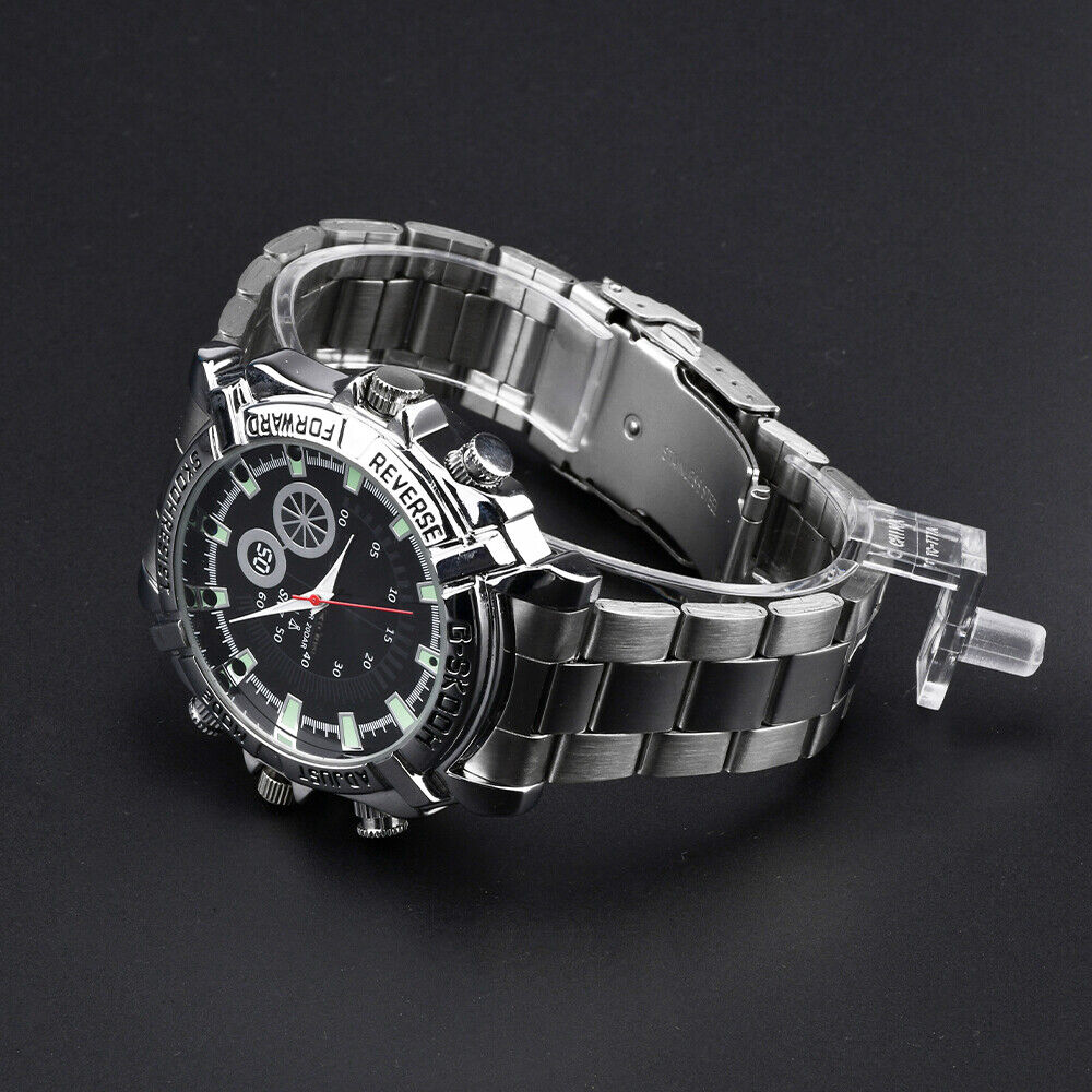 The Watch SpyCam is a stainless steel wristwatch with a black dial, luminous hour markers, and metal link band that discreetly records 1080P video & audio. Displayed on a sleek black background.