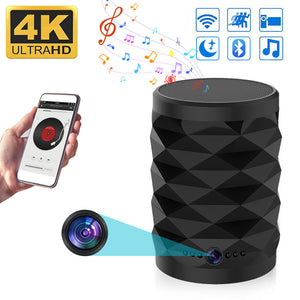The Bluetooth Speaker SpyCam is a black, cylindrical speaker with a geometric design, streaming music from a smartphone. It covertly monitors your home 24/7 with WiFi, 4K Ultra HD camera, and security features—music and camera icons with colorful notes shown.