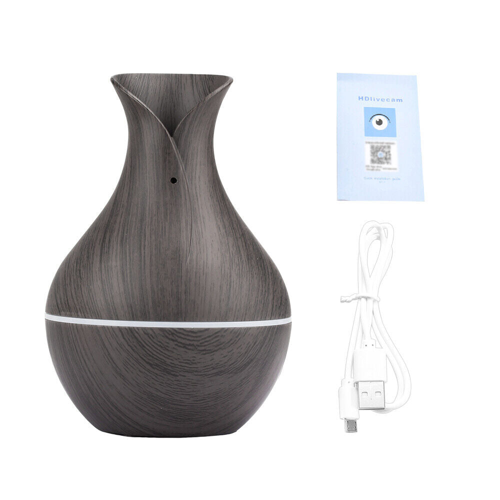 The Black Decorative Display SpyCam, with its dark wood grain vase design, elegantly enhances home décor while offering discreet surveillance. It comes with a USB cable and an instruction manual.