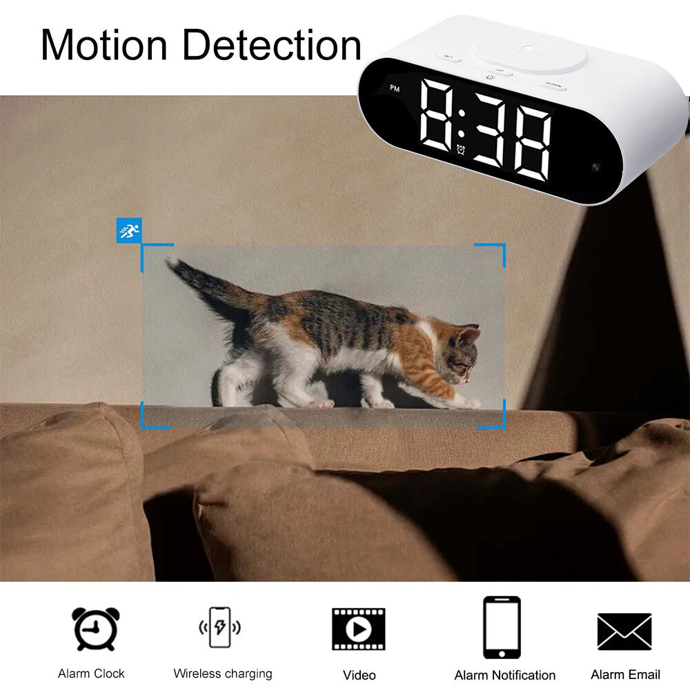 The Digital Clock Charger SpyCam captures a cat walking on a couch as icons below show its alarm, wireless charging, video recording, and notification features.