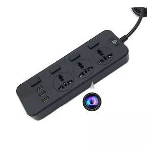 The Power Strip SpyCam, a black power strip featuring three electrical outlets, three USB ports, and an inconspicuous round object with a multicolored ring beside it, is ideal for covert surveillance with its ability to record in 1080P HD video quality.