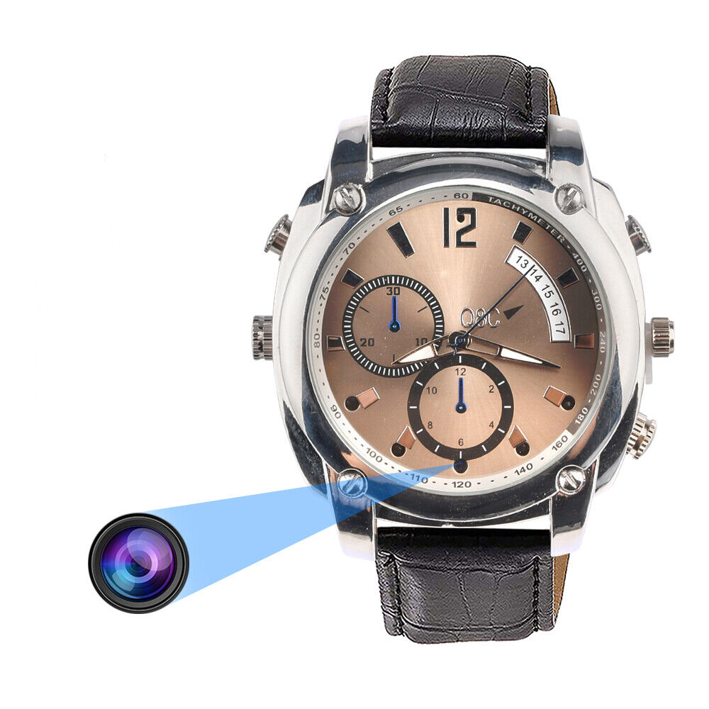 The Wristwatch SpyCam features a brown and silver face, black leather strap, and an illustrated camera lens, discreetly housing a hidden 1080P video camera inside the watch case.