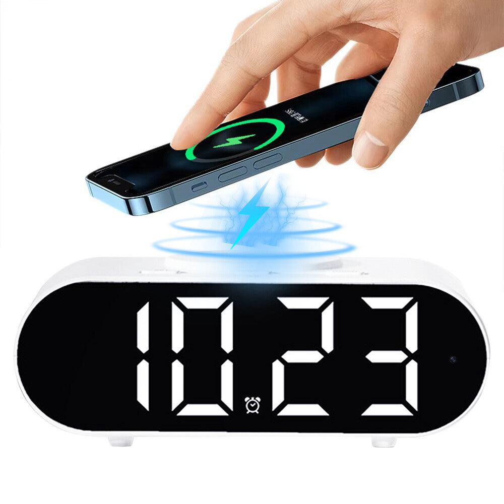 A hand places a smartphone on the Digital Clock Charger SpyCam, featuring wireless charging and built-in WiFi surveillance for enhanced security.
