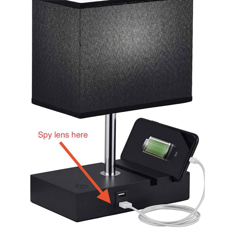 The Desk Lamp Charger SpyCam is a black rectangular lamp with a USB port and an HD 1080P spy camera at the base. It discreetly charges your phone while cleverly concealing surveillance with a "Spy lens here" indicator.