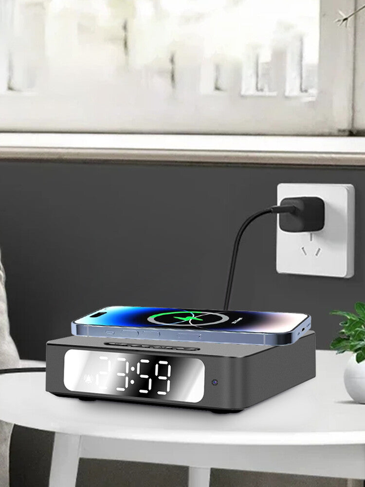 The Wireless Charger Clock SpyCam shows 21:59 while wirelessly charging a smartphone on top, all set on a small round table and plugged into the wall.
