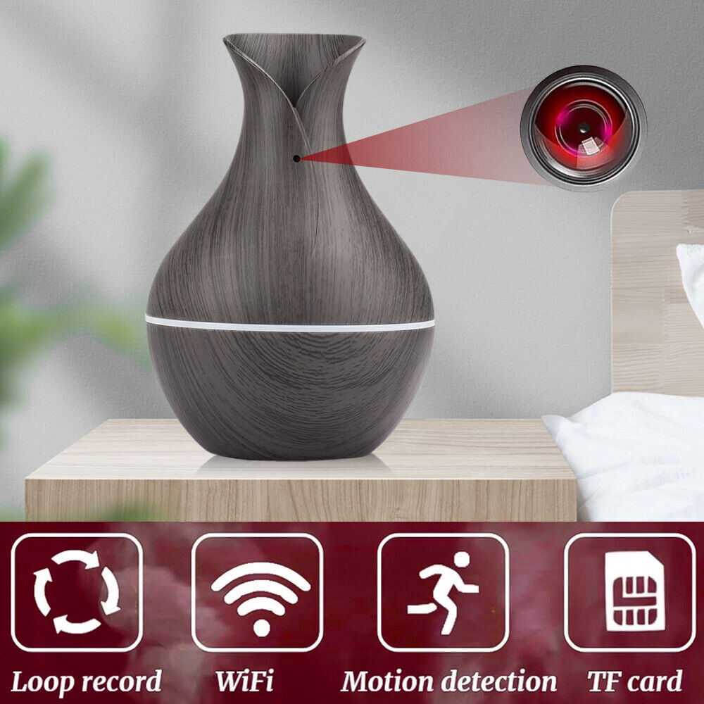 The Black Decorative Display SpyCam on a bedside table showcases icons for loop recording, WiFi, motion detection, and TF card at the bottom, merging espionage technology with modern decor.
