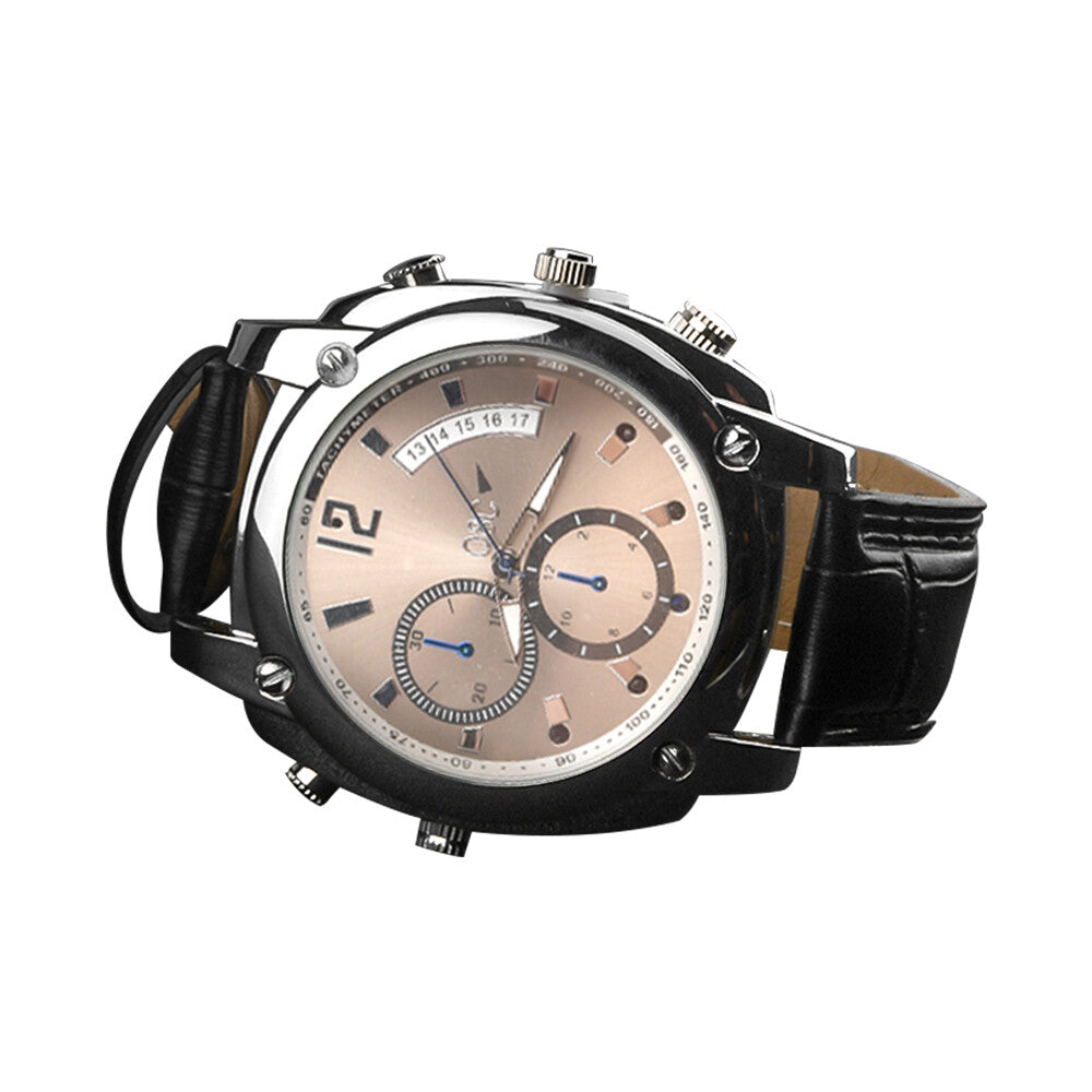 The Wristwatch SpyCam features a black leather strap, round silver case, beige dial with chronograph subdials and date display, plus a hidden camera for discreet 1080P video recording.