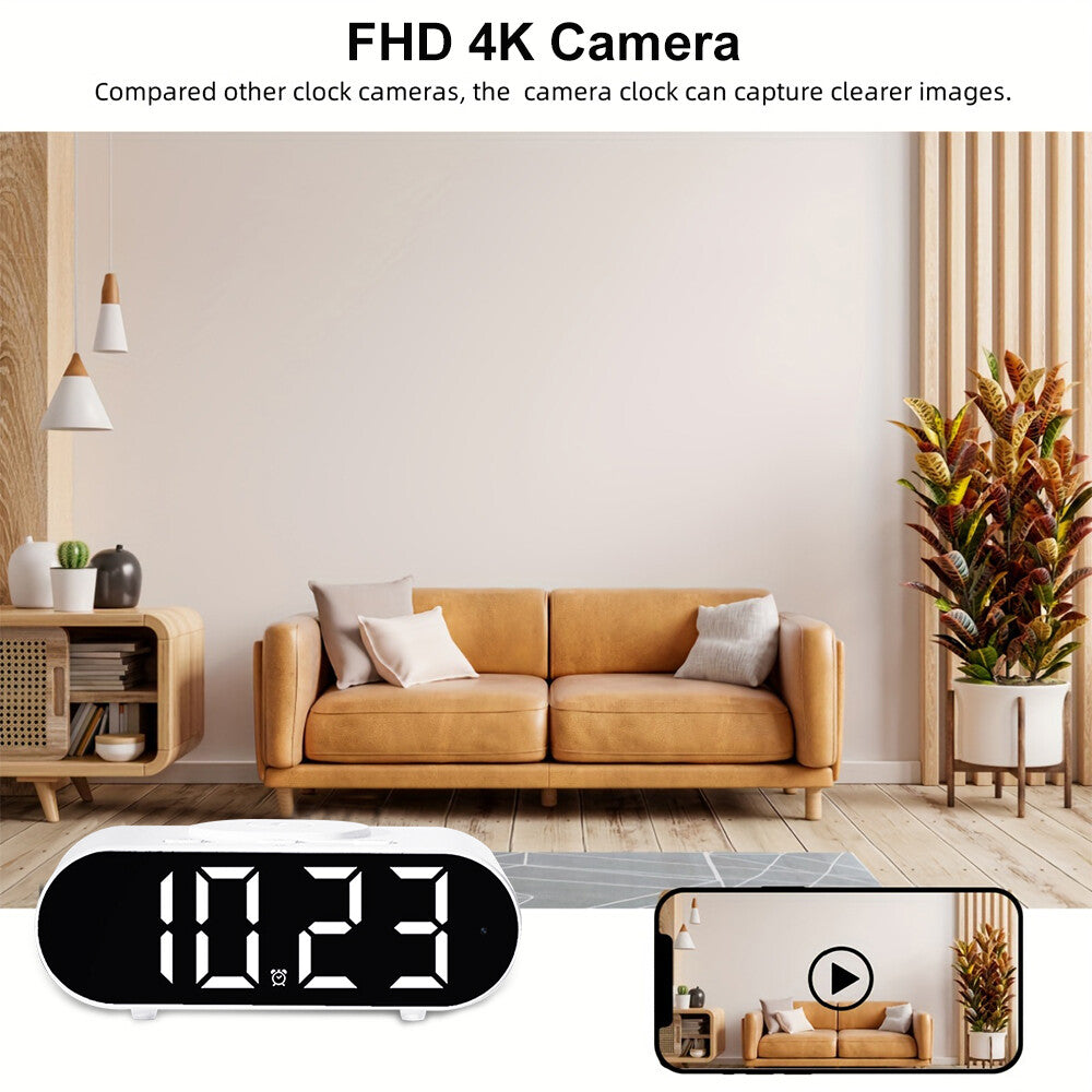 A modern living room with a tan sofa, beige wall, and plants features a Digital Clock Charger SpyCam in the foreground. The clock displays 10:23 and has built-in FHD 4K hidden camera with WiFi surveillance.