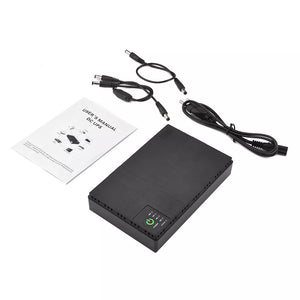 A black Portable UPS for WiFi Router with a 10400mAh capacity and indicator lights, ideal for WiFi router backup, includes a user manual, three power cables, and various connectors.