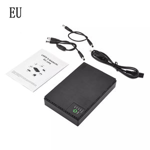 A Portable UPS for WiFi Router, featuring a black 10400mAh battery and indicator lights, is displayed on a white surface with its accompanying user manual, power cables, and connectors. It is ideal for ensuring continuous connectivity during power outages.