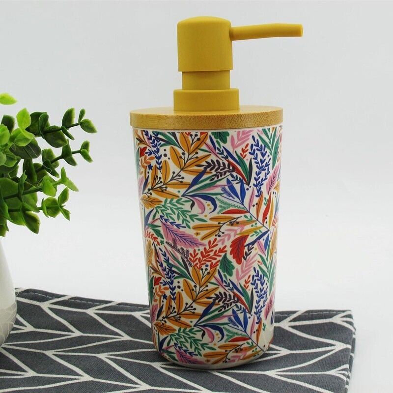 The Cute Decorative Display SpyCam, designed as a floral-patterned soap dispenser with a yellow pump, cleverly conceals a 1080P video camera on a geometric black and white surface beside a green plant, offering stylish and discreet security.