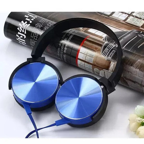 A Wired Bass Headphone with an ergonomic design and blue color rests on an open magazine.