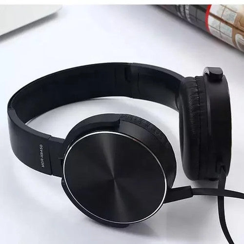 A Wired Bass Headphone with ergonomic design in black is placed on a flat white surface.