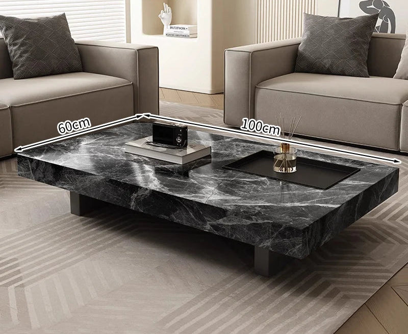 The Modern Luxe Coffee Table, a rectangular black marble piece (60 cm x 100 cm), sits between two beige sofas and enhances the sleek, modern vibe of this living room.