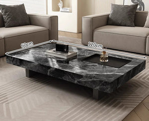 The Modern Luxe Coffee Table, a rectangular black marble piece measuring 120 x 60 cm, sits between two beige sofas on a patterned rug—an ideal addition to modern interiors.