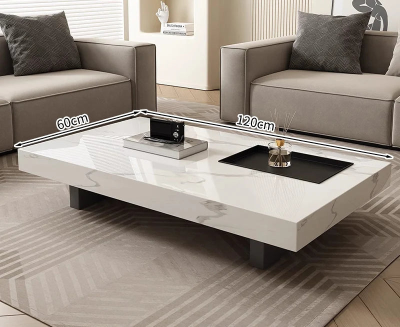 A modern living room features the Modern Luxe Coffee Table (120cm x 60cm) placed between two gray sofas on a patterned rug—an elegant touch for contemporary interiors.