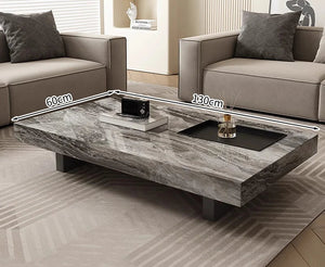 The Modern Luxe Coffee Table, a rectangular marble piece measuring 130 x 60 cm, sits between two beige sofas and enhances the modern living room’s interior.