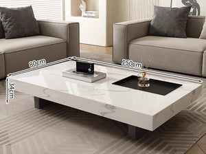 The Modern Luxe Coffee Table (150x80x34 cm) sits between two grey sofas in a living room, perfectly complementing modern interiors with its minimalist design.
