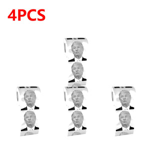 Four rolls of Trump Toilet Paper, each printed with black and white images of Trump's face, arranged on a white background with "4PCS" in bold red text.