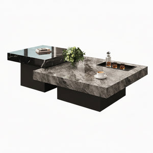 Two Modern Luxe Coffee Tables with black bases elevate modern interiors—one displays a tray with glasses and a decanter, the other holds books and a small green plant.