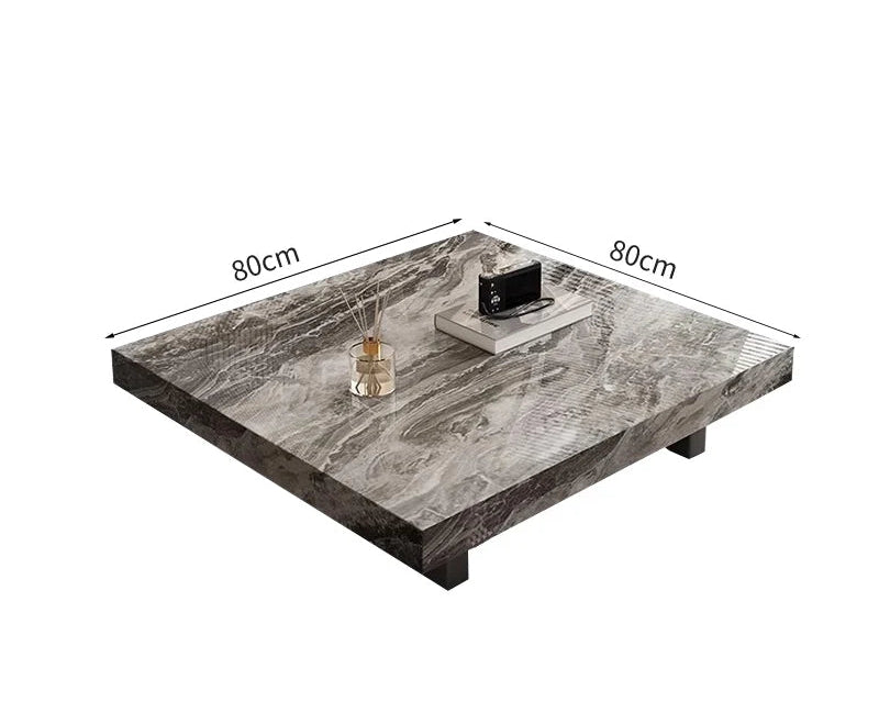 The Modern Luxe Coffee Table (80x80 cm) features a minimalist design, topped with a tray, small box, and reed diffuser—ideal for modern interiors.