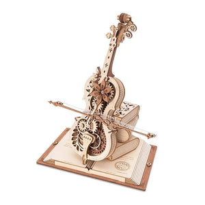 Intricate 3D Wooden Puzzle of a mechanical model resembling a cello with visible gears, mounted on a base that looks like an open book, known as the Cello Puzzle Music Box.