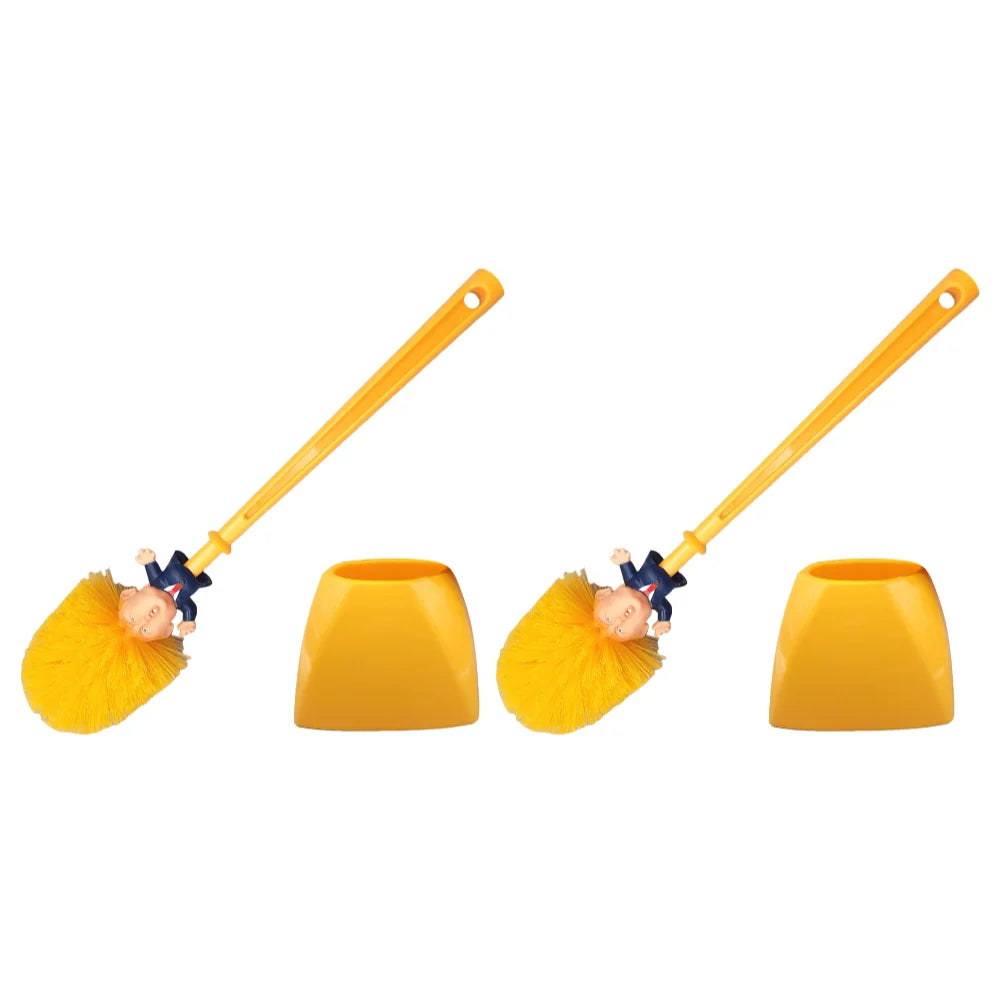 Two Trump Tidy Toilet Brushes with handles shaped like a Trump caricature and yellow holders are displayed against a white background, adding a humorous twist as a fun novelty bathroom accessory.