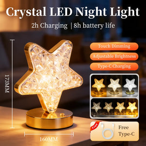 The Crystal Table Lamp is a star-shaped LED night light featuring a gold base, touch dimming, adjustable brightness, and convenient Type-C charging. This elegant lamp makes an ideal bedside accessory and comes with a complimentary charging cable. Dimensions: 173mm x 160mm.