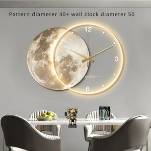 A wall with cosmic imagery showcases the Celestial Wall Clock Light overlapping a moon pattern. Below, a dining table displays a small statue, bowl of apples, and open book—ideal for unique home decor fans.