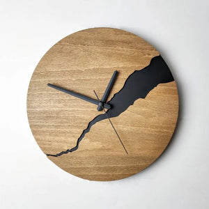 Introducing the Wooden Round Wall Clock, a rustic modern timepiece with a distinctive crack design. It boasts simple black hour and minute hands set against a natural wood finish.