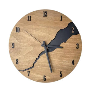 The Wooden Round Wall Clock features a rustic modern design with a natural wood finish. Bold black numbers and hands stand out against the backdrop, while a distinctive crack design runs jaggedly from top right to bottom left, adding an artistic flair to any room.