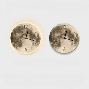 Two round Moon Wall Clocks with lunar textures: the left one glows in the dark, while the right serves as a non-illuminated decorative piece, both featuring different times.